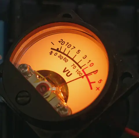 A backlit amber VU meter.